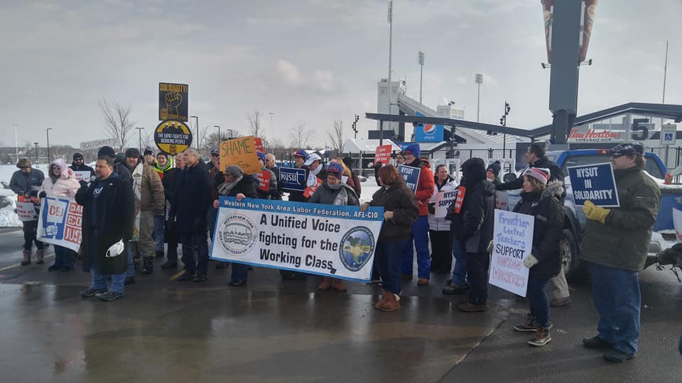 Unionists Rally Outside New Era Field To Protest The Closure Of The Pro Sports Cap Maker’s Local Production Facility, ‘Lament How Far’ Owner Christopher Koch ‘Has Fallen’ - ‘Both In Their Eyes & The Eyes Of The Community’ 